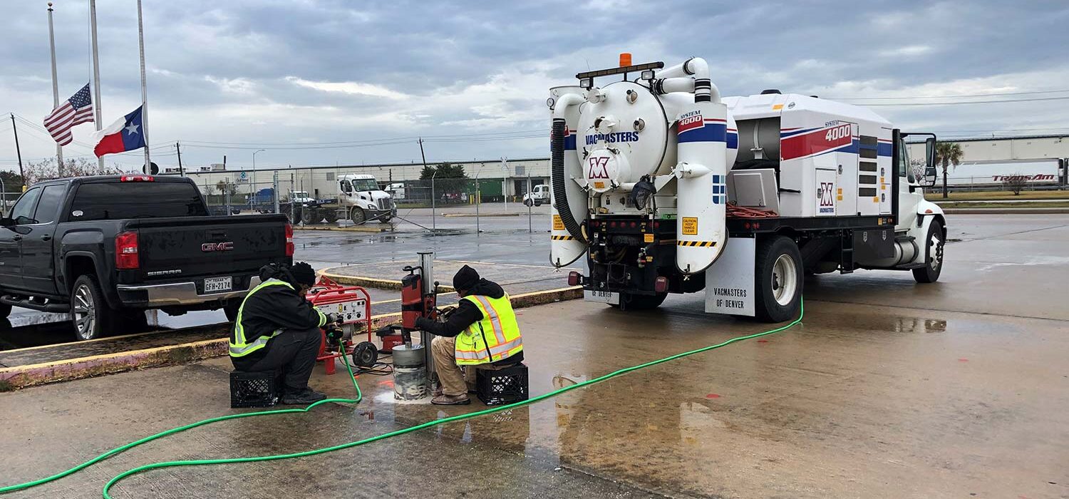 crew members working with vacuum truck outside